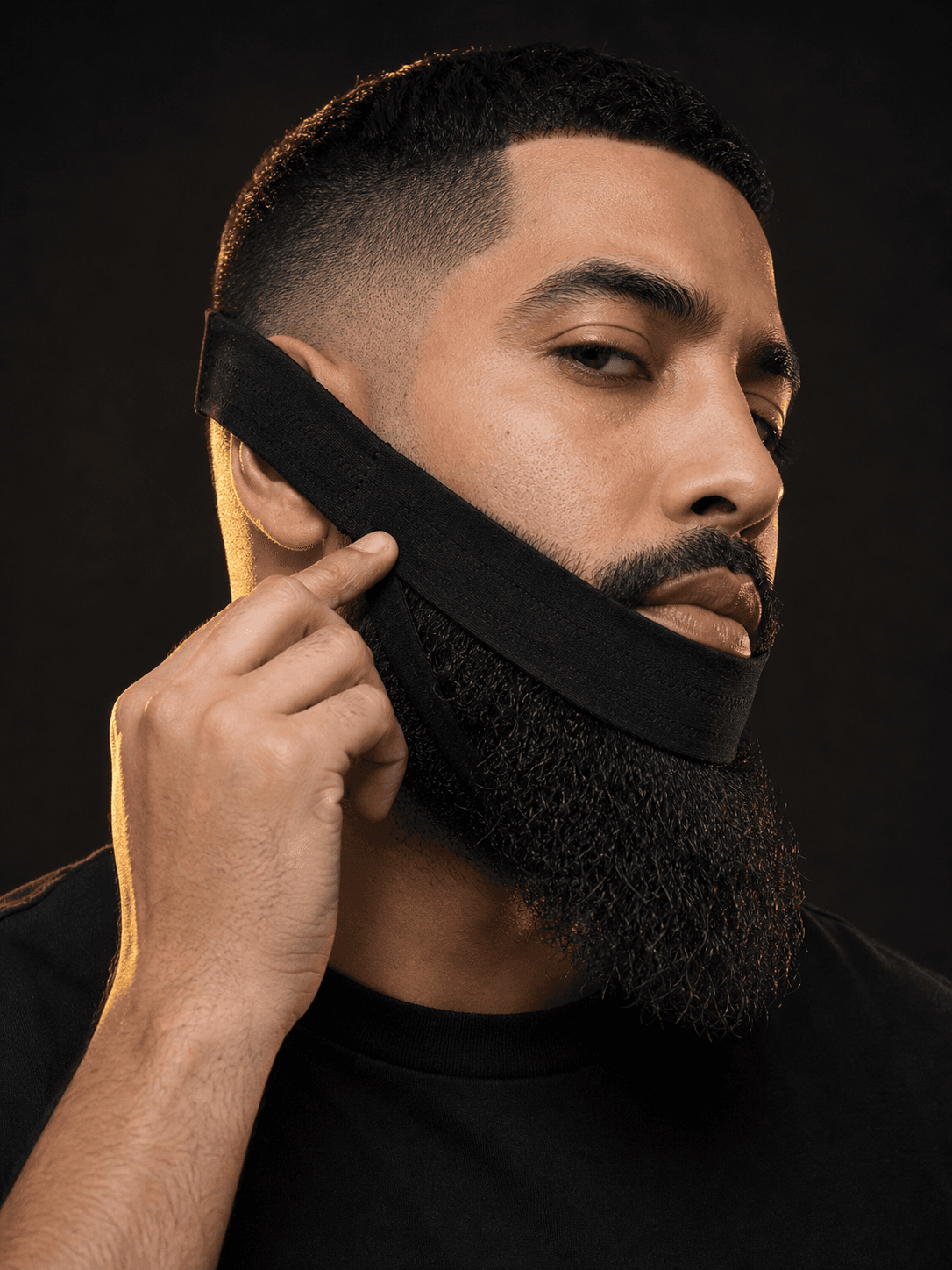 Professional model aligning the BeardBand edge along his cheek