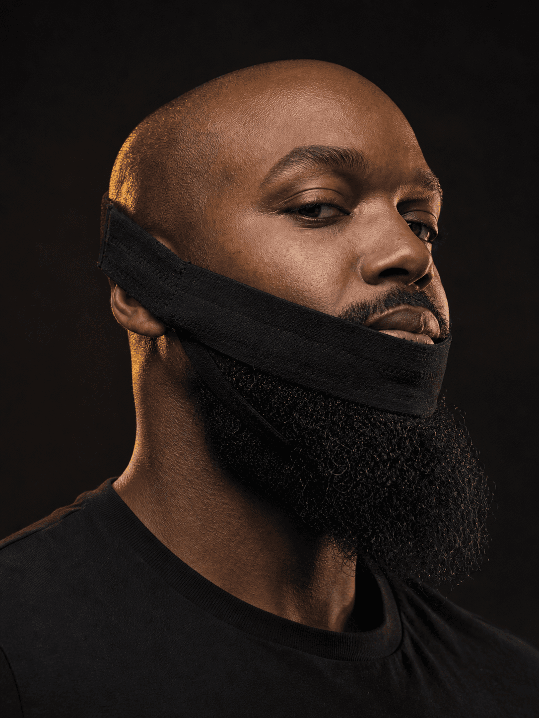 Professional model wearing the black BeardBand around a full beard